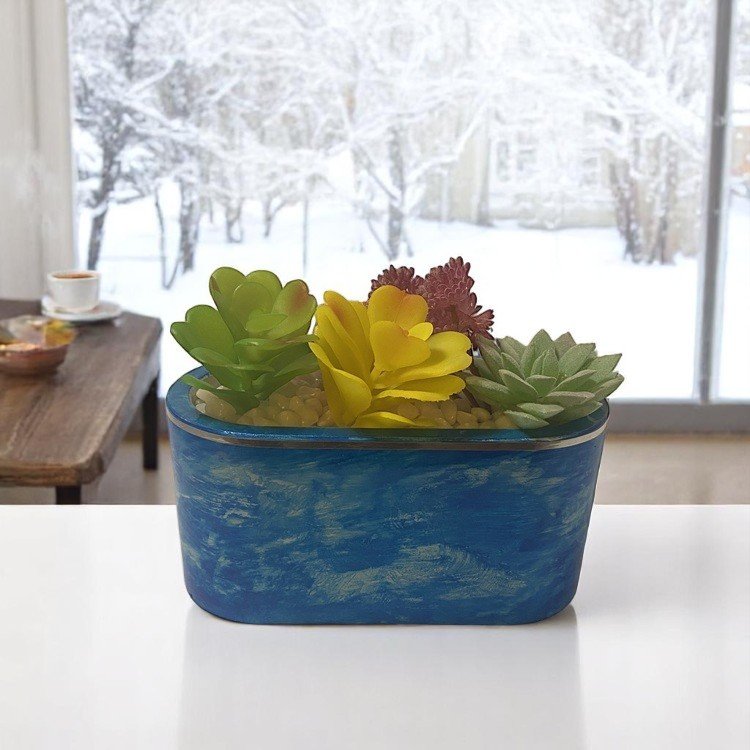 Winterspell Blue Oval Cement Planter with succulents on a countertop